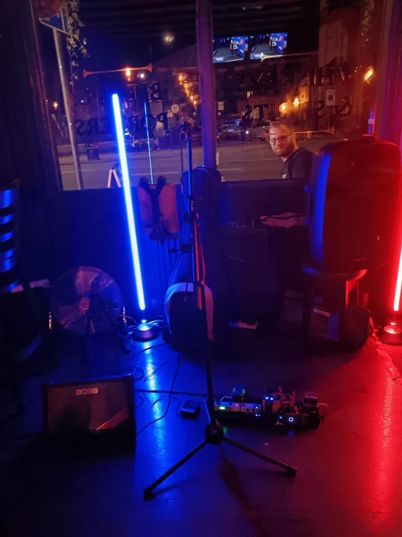 Red and blue lighting, microphone, pedalboard and speakers at The Derby